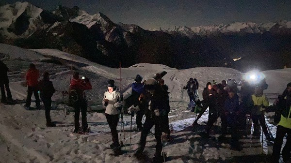 Snowshoeing under the moonlight with ski instructors