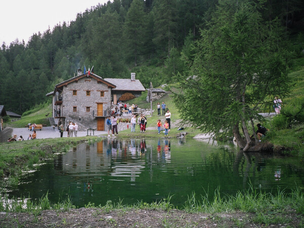 Berghütte Chaligne – Außenansicht im Sommer am Ufer des kleinen Stausees