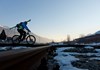 By bike, carrying skis towards the start of the Aosta-Pila gondola