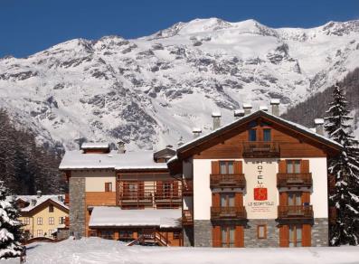 The hotel Lo Scoiattolo under the snow and the Monte Rosa
